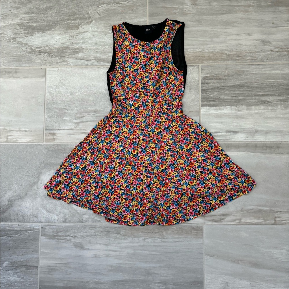 Floral sleeveless flippy dress with mesh back. Size 2.